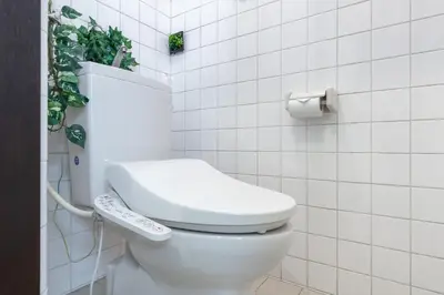 a bathroom with a white toilet with a remote control at -Room MtFuji- Max 9 people 8 minutes to Shibuya 5 minutes to Shinjuku 1 minute to Harajuku 4 minutes walk from the station in Tokyo
