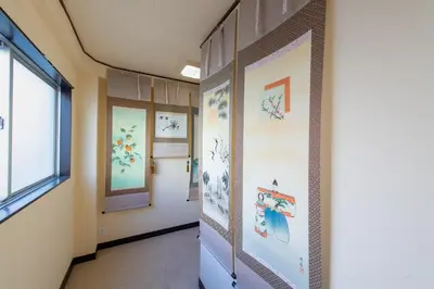 a corridor of a classroom with paintings on the walls at -Room MtFuji- Max 9 people 8 minutes to Shibuya 5 minutes to Shinjuku 1 minute to Harajuku 4 minutes walk from the station in Tokyo