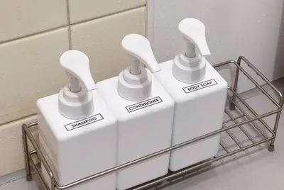 three white toothbrushes sitting on a rack in a bathroom at -Room MtFuji- Max 9 people 8 minutes to Shibuya 5 minutes to Shinjuku 1 minute to Harajuku 4 minutes walk from the station in Tokyo