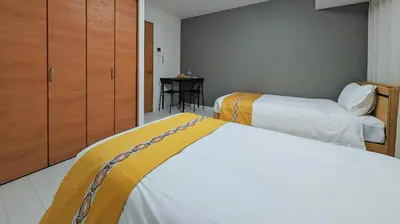 a hotel room with two beds and a closet at incense\u4e0a\u91ce\u6839\u5cb85\uff26 in Tokyo