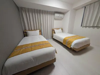 a room with two beds in a room at incense\u4e0a\u91ce\u6839\u5cb85\uff26 in Tokyo
