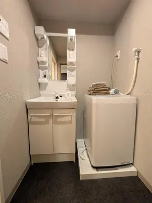 a bathroom with a sink and a toilet and a mirror at incense\u4e0a\u91ce\u6839\u5cb85\uff26 in Tokyo