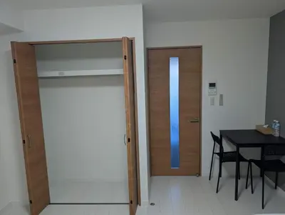 a room with a door and a table and a bed at incense\u4e0a\u91ce\u6839\u5cb85\uff26 in Tokyo