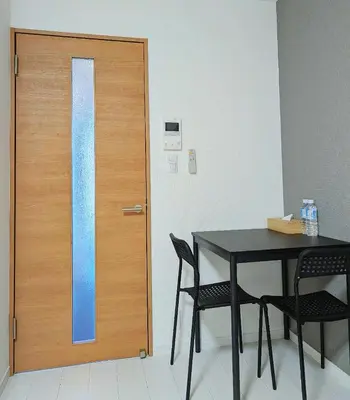 a room with a table and a door with chairs at incense\u4e0a\u91ce\u6839\u5cb85\uff26 in Tokyo