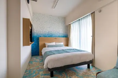 a bedroom with a bed with a blue wall at Hotel TOKI \u5b63 in Tokyo