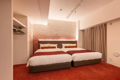 a bedroom with a large bed with a red carpet at Hotel TOKI \u5b63 in Tokyo