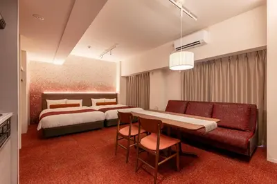 a hotel room with a bed and a table and chairs at Hotel TOKI \u5b63 in Tokyo