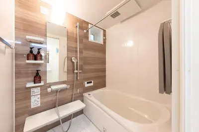 a bathroom with a bath tub and a sink at FINOA Residential Suite Takaido in Tokyo