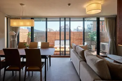 a living room with a couch and a table at Noël Shibuya Once -Luxury Residence in Tokyo