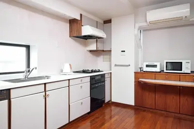 a kitchen with a sink and a stove top oven at Noël Shibuya Once -Luxury Residence in Tokyo
