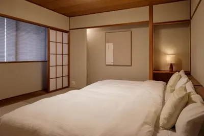 a large white bed in a room with a window at Noël Shibuya Once -Luxury Residence in Tokyo