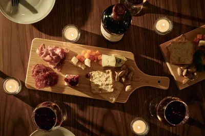 a wooden cutting board with different types of food on a table at Noël Shibuya Once -Luxury Residence in Tokyo