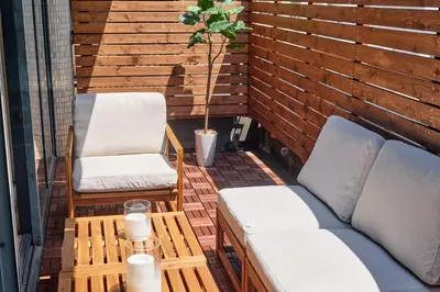 a patio with two chairs and a couch and a plant at Noël Shibuya Once -Luxury Residence in Tokyo