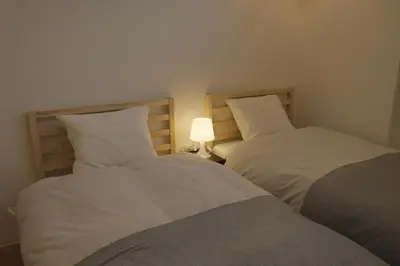 two beds sitting next to each other in a room at Dori Dori House Ebisu in Tokyo