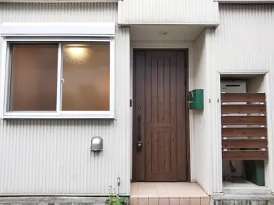 a house with a wooden door and a window at Dori Dori House Ebisu in Tokyo