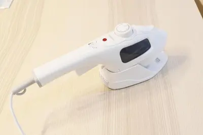 a white electric hair dryer sitting on a wooden table at Dori Dori House Ebisu in Tokyo