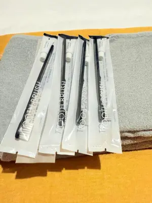a pile of toothbrushes sitting on top of a table at \u6c60\u888b\u672c\u753a303 in Tokyo