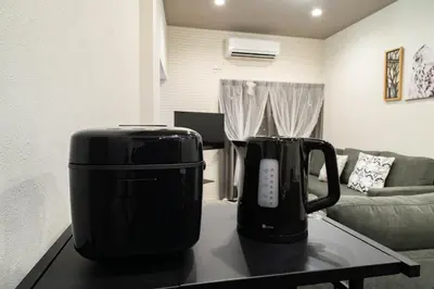 two black appliances sitting on a coffee table in a living room at \u30a2\u30f3\u30c9\u30b9\u30c6\u30a4\u5800\u52076\u4e01\u76ee in Tokyo