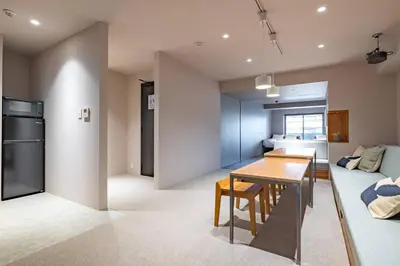 a kitchen and living room with a table and a couch at 9Stay \u83ca\u5ddd in Tokyo