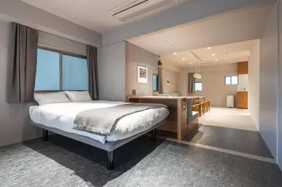 a bedroom with a bed and a kitchen and a bathroom at 9Stay \u83ca\u5ddd in Tokyo