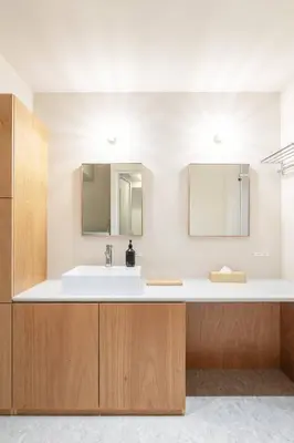 a bathroom with a sink and two mirrors at 9Stay \u83ca\u5ddd in Tokyo