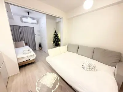 a living room with a couch and a bed at Ying-Higashi Shinjuku-SJ0061 in Tokyo