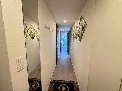 a hallway with a wooden floor and a hallway with a mirror at Ying-Higashi Shinjuku-SJ0061 in Tokyo