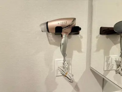 a hairdryer hanging on a wall at Ying-Higashi Shinjuku-SJ0061 in Tokyo