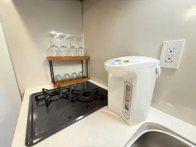 a kitchen with a stove and a counter top at Ying-Higashi Shinjuku-SJ0061 in Tokyo