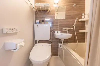 a small bathroom with a toilet and a sink at Shinjuku two stations, three-bedroom apartment, 6 people, seven minutes from Higashi-Nakano station in Tokyo