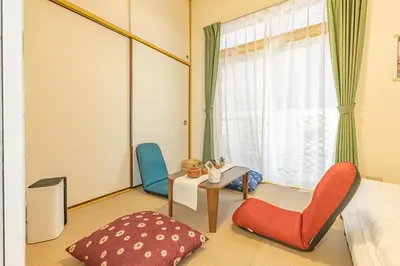 a room with two chairs and a table and a window at Shinjuku two stations, three-bedroom apartment, 6 people, seven minutes from Higashi-Nakano station in Tokyo