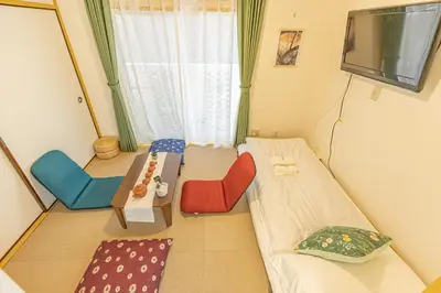 a room with a couch and chairs and a tv at Shinjuku two stations, three-bedroom apartment, 6 people, seven minutes from Higashi-Nakano station in Tokyo