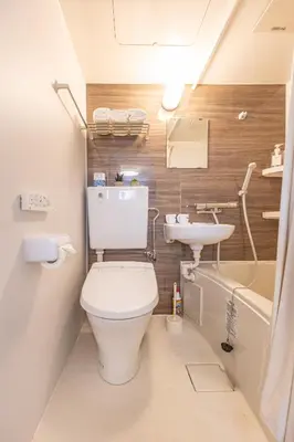a small bathroom with a toilet and a sink at Shinjuku two stations, three-bedroom apartment, 6 people, seven minutes from Higashi-Nakano station in Tokyo