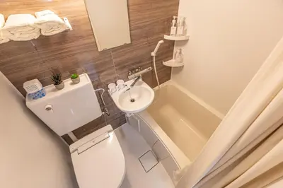 a small bathroom with a toilet and a sink at Shinjuku two stations, three-bedroom apartment, 6 people, seven minutes from Higashi-Nakano station in Tokyo