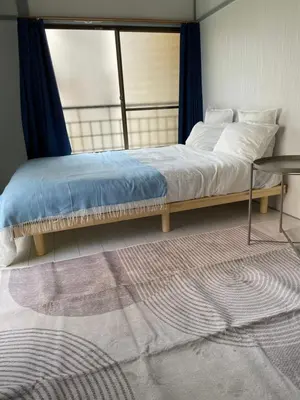 a bedroom with a large bed with a window at Dolce Vita Ebisu in Tokyo