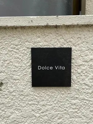 a sign on the side of a building at Dolce Vita Ebisu in Tokyo