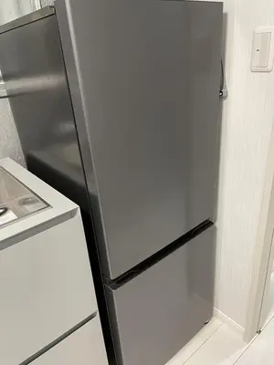 a stainless steel refrigerator in a kitchen next to a stove at Dolce Vita Ebisu in Tokyo