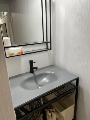 a bathroom with a sink and a mirror at Dolce Vita Ebisu in Tokyo