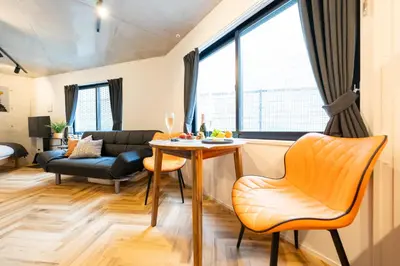 a living room with a table and a couch at GLANNIR Higashi kitazawa 102 in Tokyo