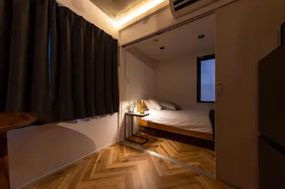 a small bedroom with a bed and a window at GLANNIR Higashi kitazawa 102 in Tokyo