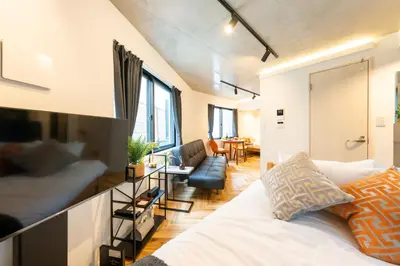 a bedroom with a bed and a living room at GLANNIR Higashi kitazawa 102 in Tokyo
