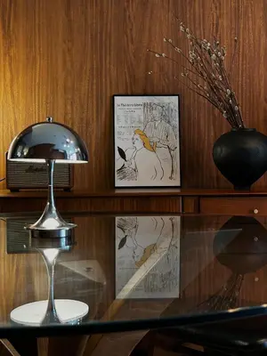 a glass table with a lamp and pictures on a shelf at \u4e2d\u91ce\u99c5\u5357inn Nakano Station South Inn in Tokyo