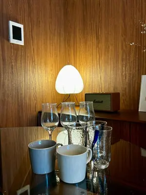 a table with wine glasses and a lamp on it at \u4e2d\u91ce\u99c5\u5357inn Nakano Station South Inn in Tokyo