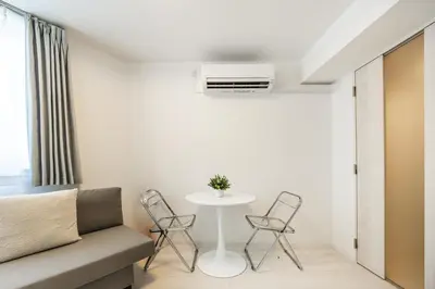 a small living room with a table and chairs at SJ Stay in Tokyo