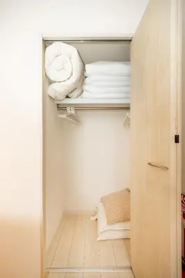 a closet with a door open with towels at SJ Stay in Tokyo