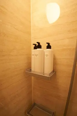 two rolls of toilet paper on a shelf in a bathroom at SGC\u8535\u524d2\u4e01\u76ee4f in Tokyo