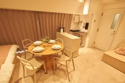 a table and chairs in a room with a kitchen at SGC\u8535\u524d2\u4e01\u76ee4f in Tokyo