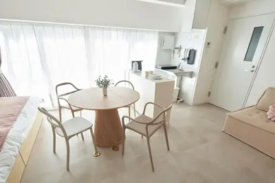 a living room with a table and chairs and a kitchen at SGC\u8535\u524d2\u4e01\u76ee4f in Tokyo