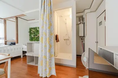 a bathroom with a shower and a bedroom at Private Floors 2F and 3 to 5F for up to 18 Guests 8 min walk from JR Hamamatsucho HOTEL Musashi Tokyo Shiba in Tokyo