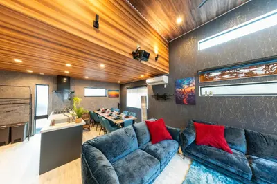 a living room with a couch and a kitchen at 3-minute walk from Nishi-Shinjuku Station 100square meters Entire Private House 4LDK in Tokyo